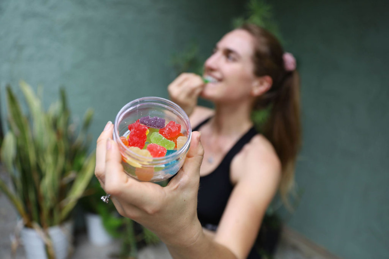 woman standing with cbd gummies