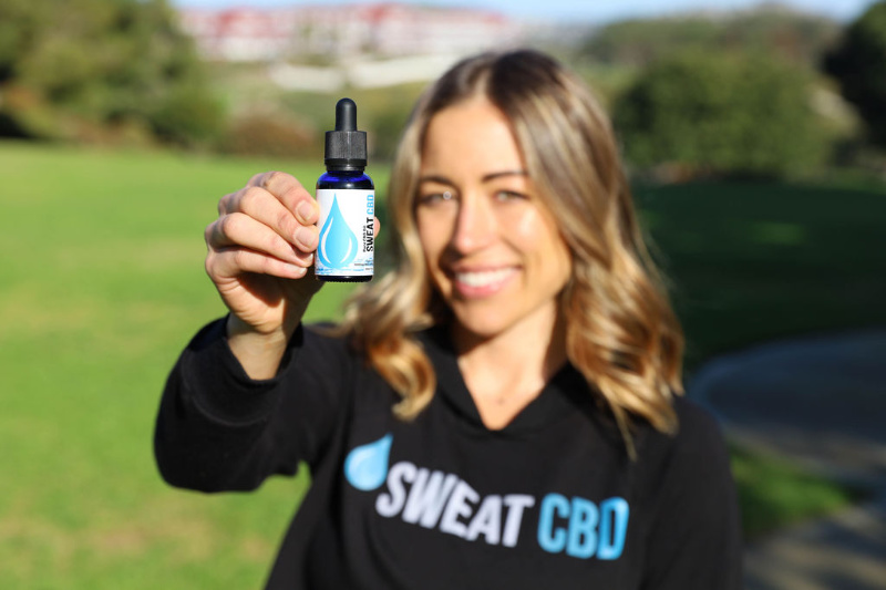 woman standing with sweatcbd product